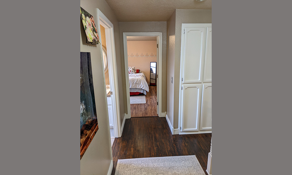Upstairs Hall View of Linen Closet and Into Second Bedroom